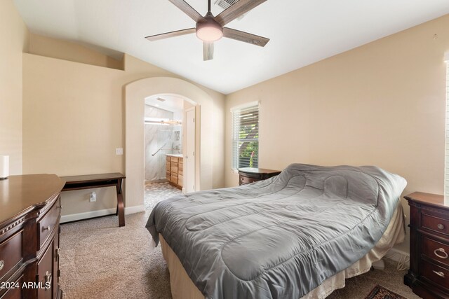 bedroom featuring ensuite bathroom, ceiling fan, and light colored carpet