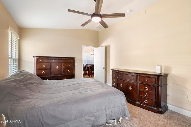 carpeted bedroom featuring ceiling fan and vaulted ceiling