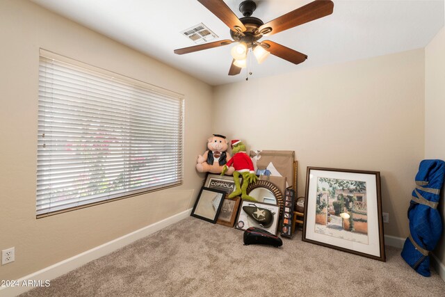 misc room featuring ceiling fan and light carpet