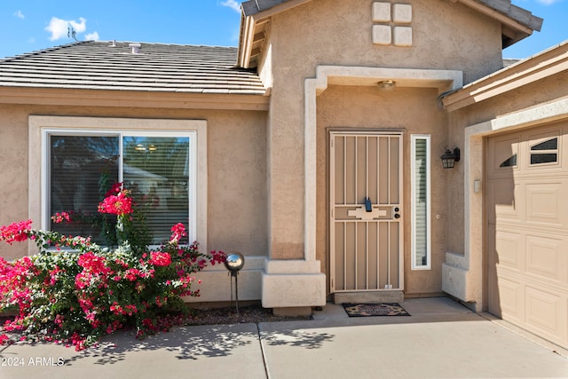 view of exterior entry with a garage