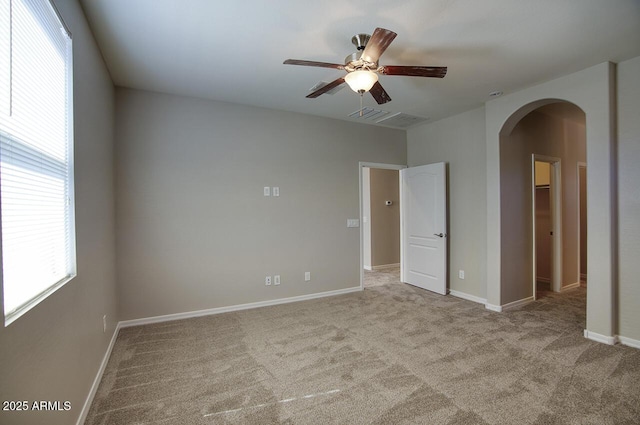 4242 E Erie St, Gilbert, AZ 85295 - unfurnished room with arched walkways, a ceiling fan, carpet, and baseboards