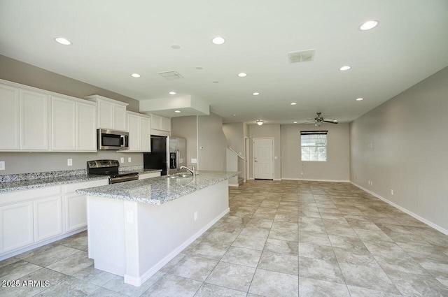 4242 E Erie St, Gilbert, AZ 85295 - kitchen with stainless steel appliances, recessed lighting, an island with sink, ceiling fan, and white cabinetry