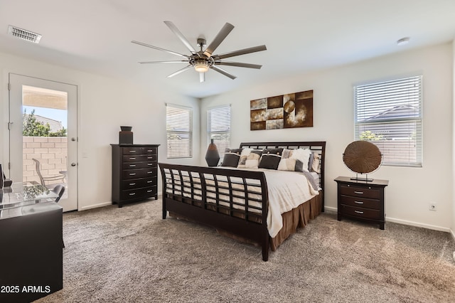 7665 W Fetlock Trl, Peoria, AZ 85383 - carpeted bedroom featuring multiple windows, a ceiling fan, and access to exterior