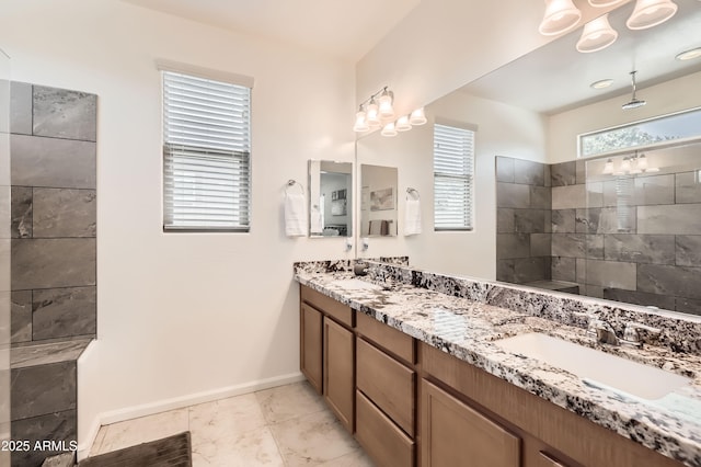 7665 W Fetlock Trl, Peoria, AZ 85383 - bathroom with double vanity, a chandelier, and a tile shower