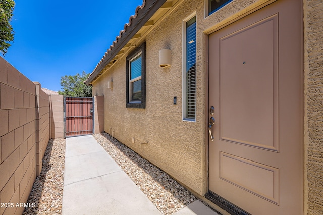 7665 W Fetlock Trl, Peoria, AZ 85383 - doorway to property featuring a gate and stucco siding