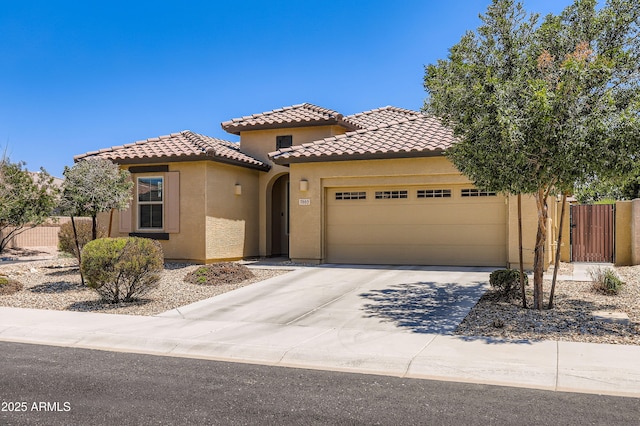 7665 W Fetlock Trl, Peoria, AZ 85383 - mediterranean / spanish house featuring an attached garage, stucco siding, a tiled roof, and driveway