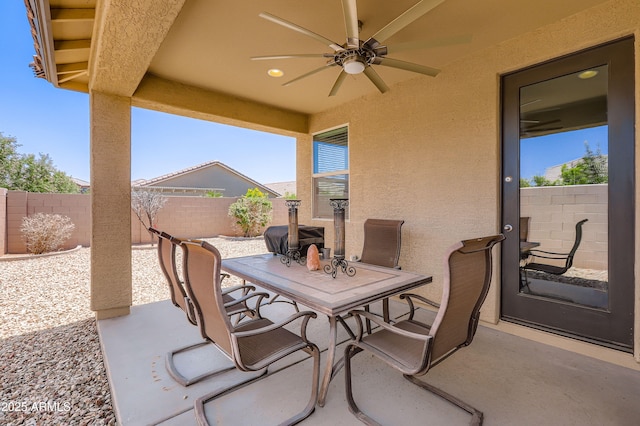 7665 W Fetlock Trl, Peoria, AZ 85383 - fenced backyard with a patio, ceiling fan, and outdoor dining area