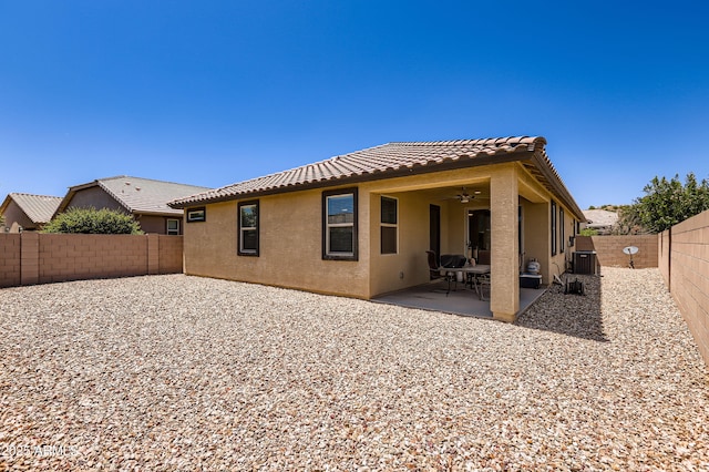 7665 W Fetlock Trl, Peoria, AZ 85383 - rear view of property with stucco siding, a tiled roof, a ceiling fan, a fenced backyard, and a patio