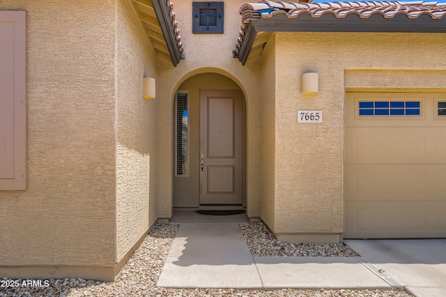 7665 W Fetlock Trl, Peoria, AZ 85383 - doorway to property with stucco siding and a tiled roof