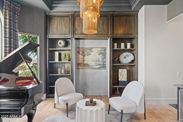 sitting room featuring a wealth of natural light, built in features, and light wood-type flooring