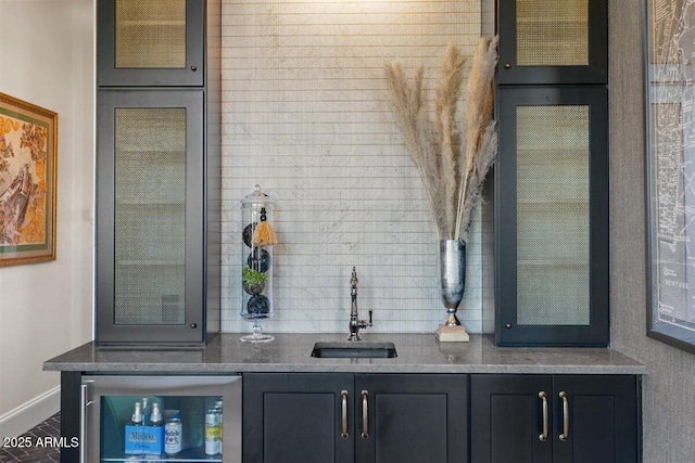 bar featuring beverage cooler and sink