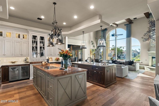 kitchen featuring white cabinetry, wood counters, dark brown cabinetry, and a center island