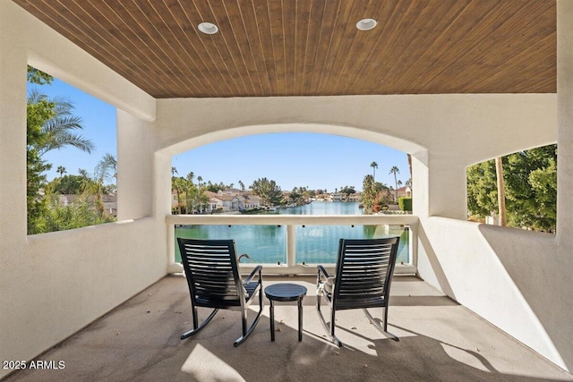 view of patio / terrace featuring a balcony and a water view