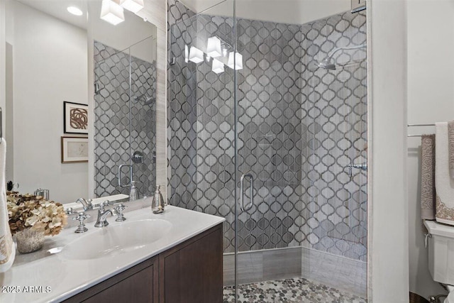 bathroom with walk in shower and vanity