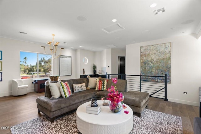 living room featuring an inviting chandelier and wood-type flooring