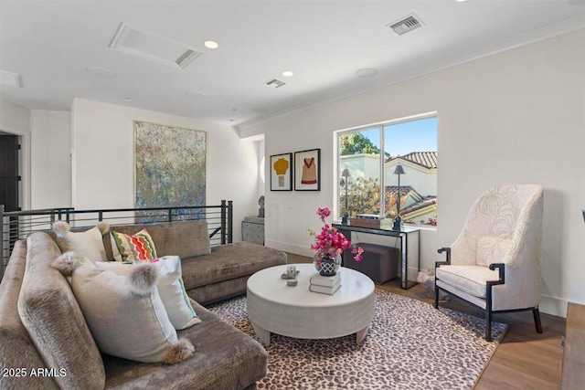 living room with hardwood / wood-style flooring and ornamental molding