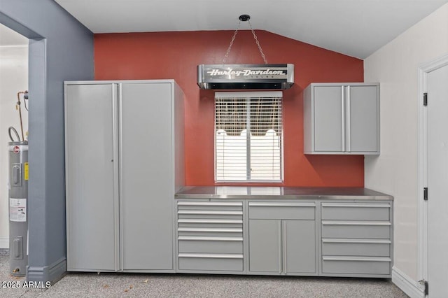 kitchen with decorative light fixtures, gray cabinets, and vaulted ceiling