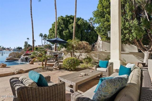 view of patio with an outdoor hangout area and a water view