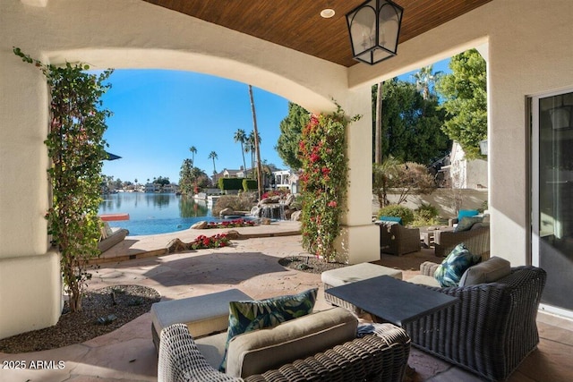 view of patio featuring a water view and outdoor lounge area