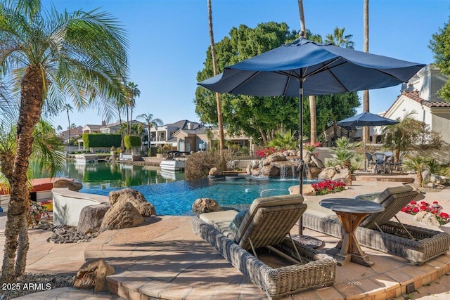 view of pool with a water view, a patio, and pool water feature