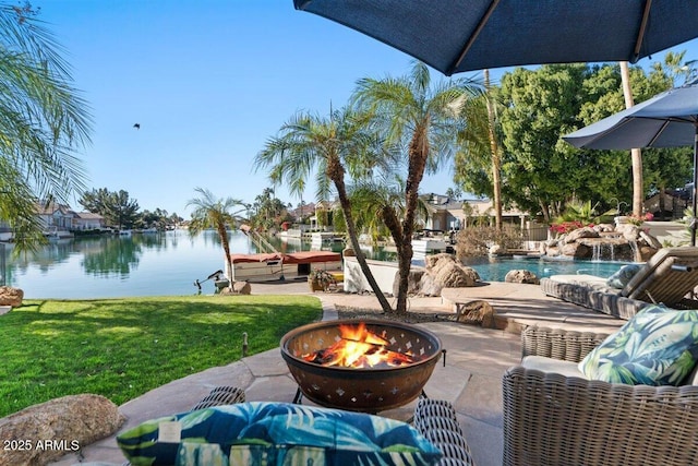 view of patio / terrace featuring a water view and an outdoor fire pit