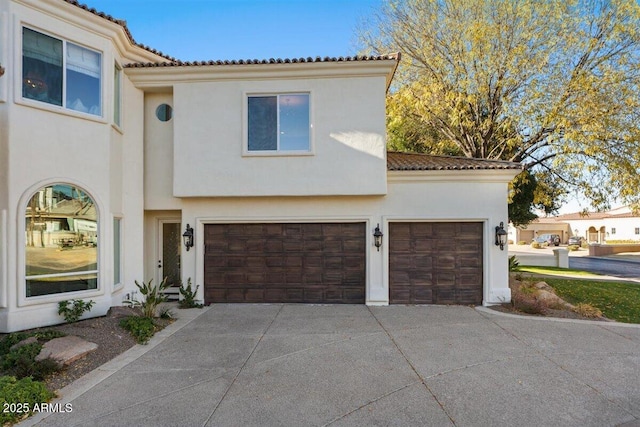 mediterranean / spanish home featuring a garage