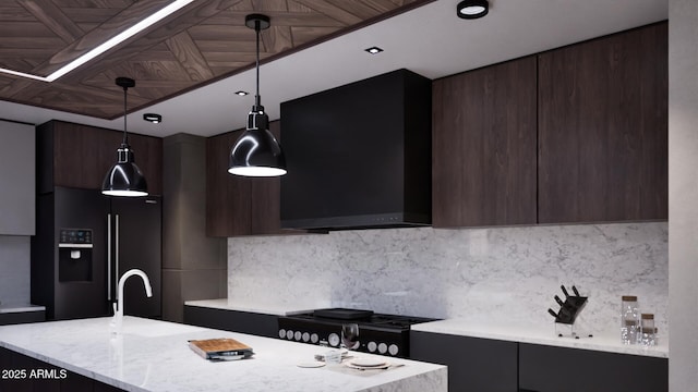 kitchen featuring pendant lighting, wall chimney range hood, backsplash, black fridge with ice dispenser, and stove