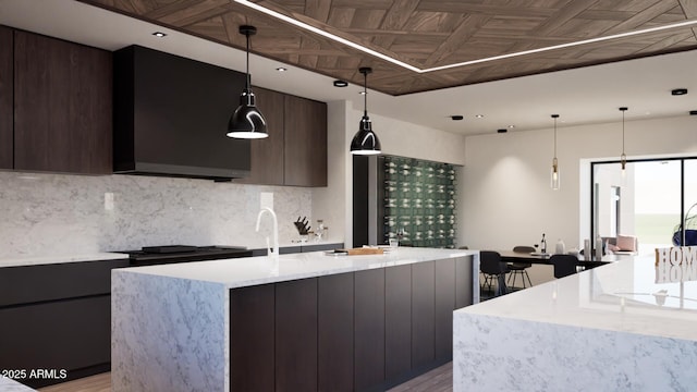 kitchen featuring light stone countertops, pendant lighting, dark brown cabinets, and tasteful backsplash