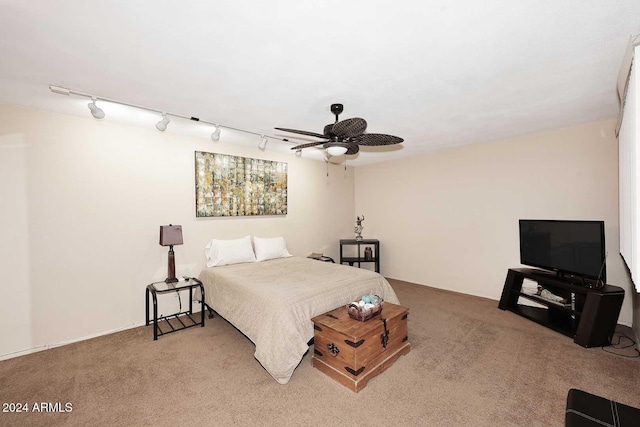 carpeted bedroom with rail lighting and ceiling fan