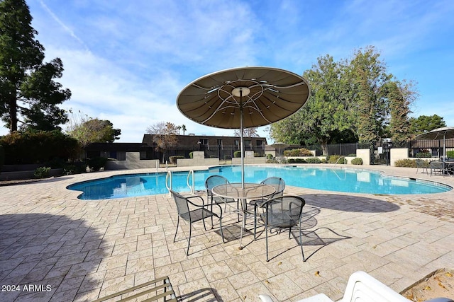 view of swimming pool with a patio area