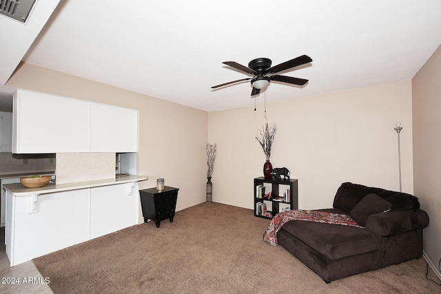 sitting room featuring ceiling fan and light colored carpet