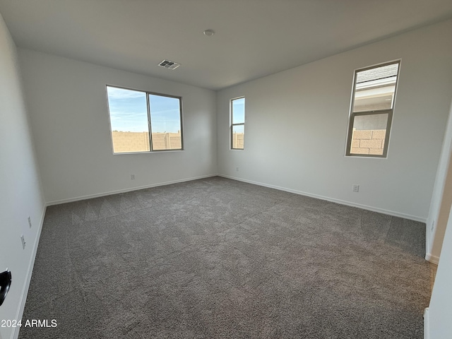 empty room featuring dark colored carpet