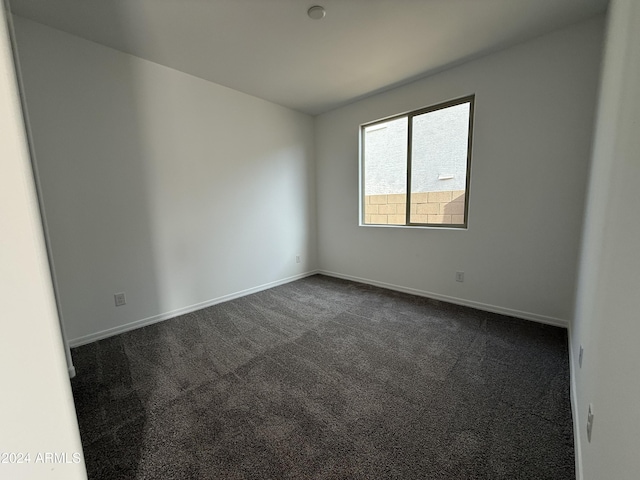 empty room with dark carpet