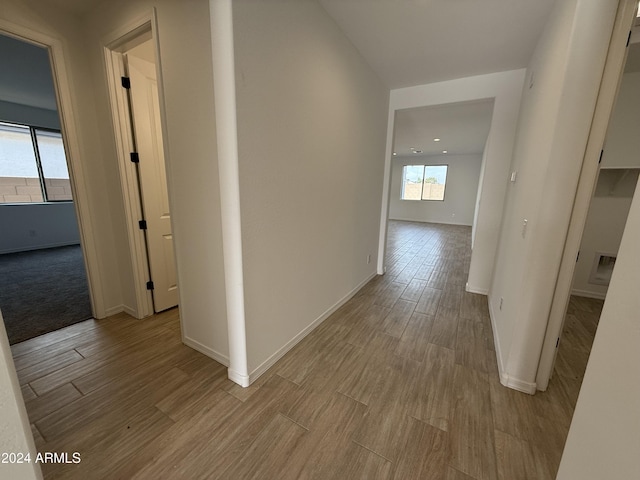 hallway with light hardwood / wood-style floors