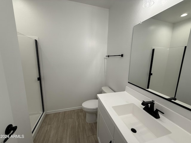 bathroom with vanity, hardwood / wood-style flooring, toilet, and walk in shower