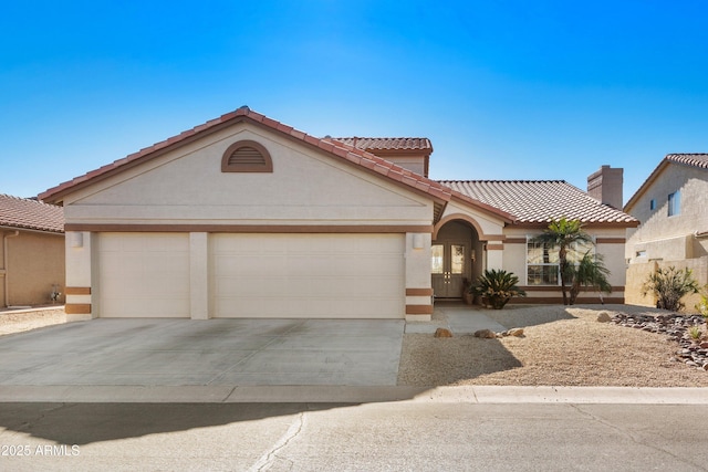 mediterranean / spanish-style house with a garage