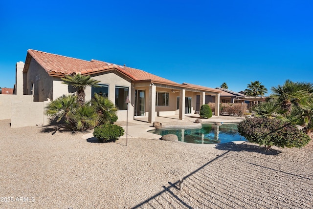 back of property with a patio area and ceiling fan