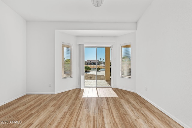 spare room featuring light wood-type flooring