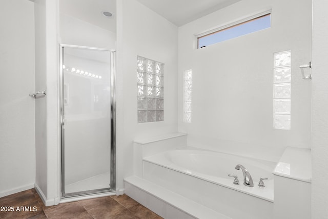 bathroom featuring separate shower and tub