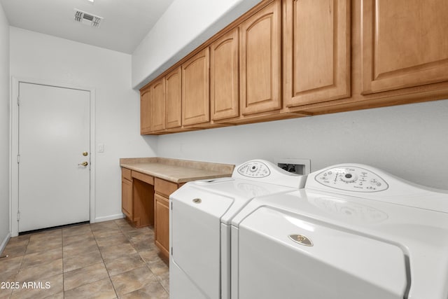 laundry area with separate washer and dryer and cabinets