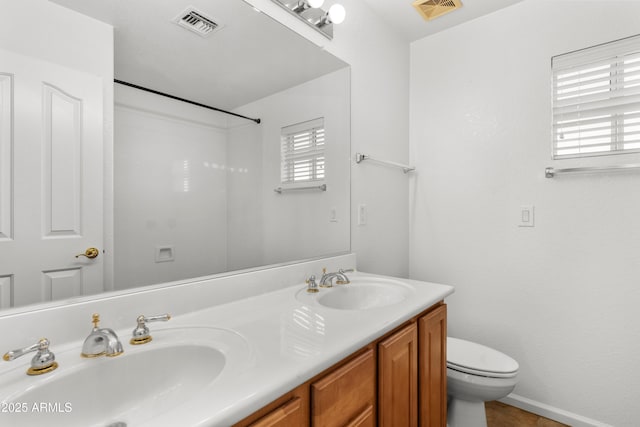 bathroom featuring toilet and vanity