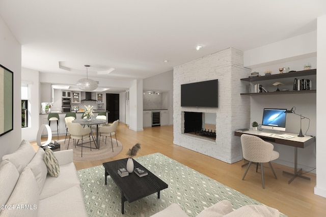 living room featuring a fireplace, light hardwood / wood-style floors, and beverage cooler