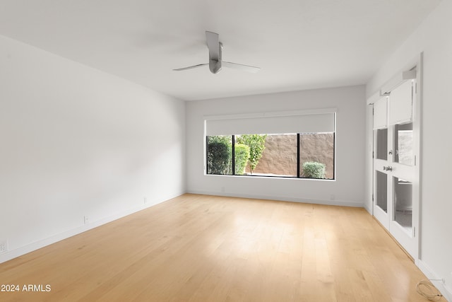 unfurnished room featuring ceiling fan and light hardwood / wood-style flooring