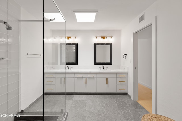 bathroom with vanity and a shower