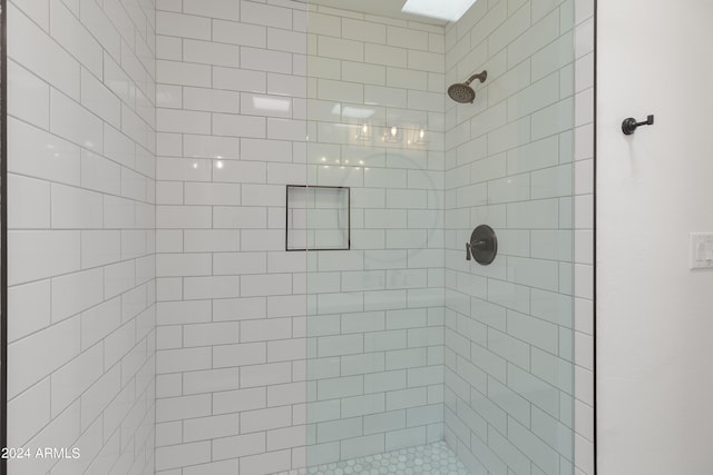 bathroom with a tile shower