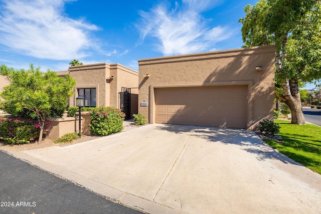 pueblo-style home featuring a garage