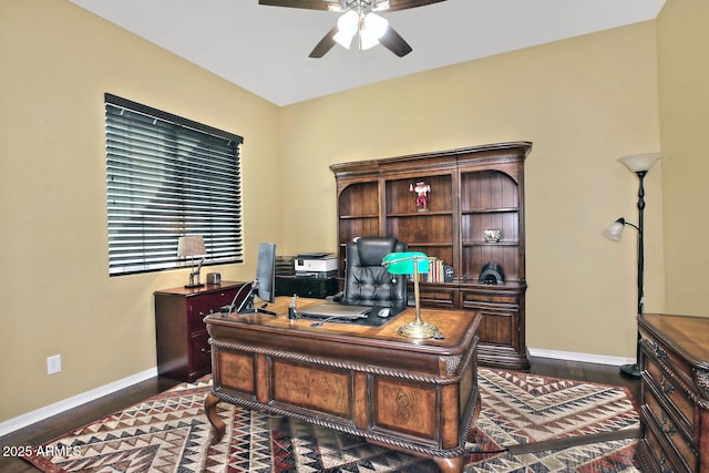 home office featuring ceiling fan and dark hardwood / wood-style flooring