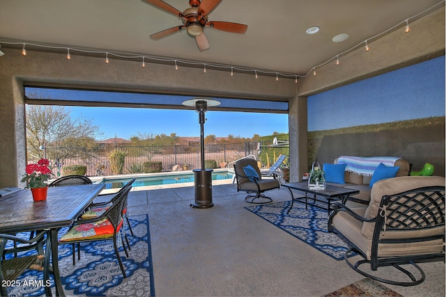 view of patio / terrace featuring a fenced in pool, an outdoor living space, and ceiling fan