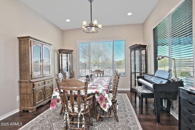 dining area with a notable chandelier and dark hardwood / wood-style floors