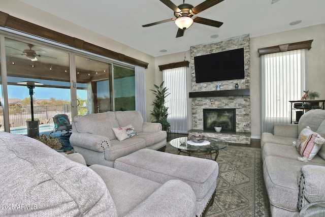 living room featuring a fireplace and ceiling fan